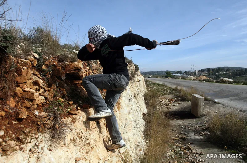 A Palestinian demonstrator takes part in a weekly protest against the construction of Israel's controversial separation barrier and the expansion of Jewish settlements in the West Bank village of Nabi Saleh near Ramallah...
