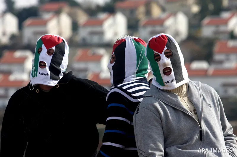 Palestinian demonstrators take a break during clashes with Israeli soldiers during a protest against the expansion of the nearby Jewish settlement of Halamish in the West Bank village of Nabi Saleh, near Ramallah, Friday...