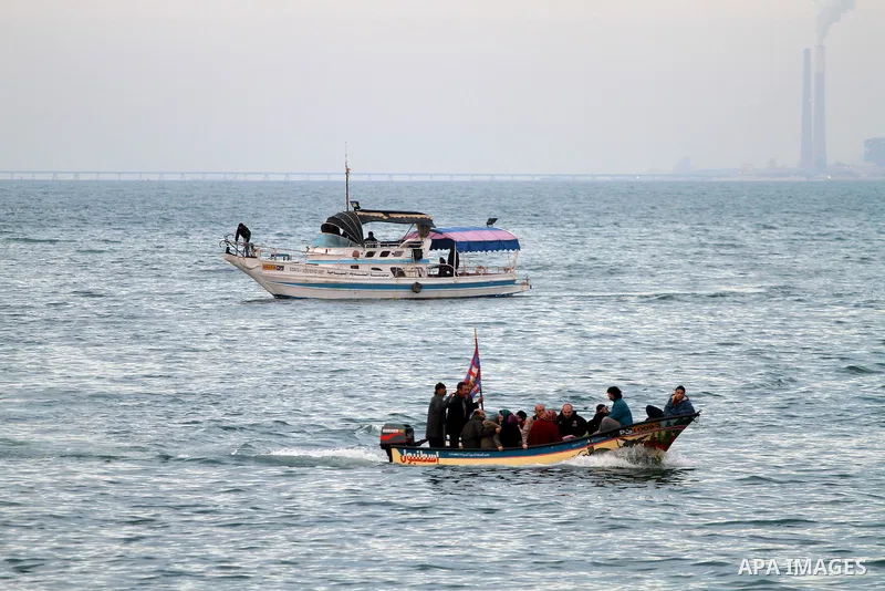 Palestinian men ride their boat near the beach during sunset ,in Gaza City on Feb. 04, 2012. Photo by Mohammed Asad