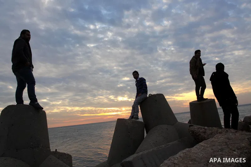 Palestinian men is silhouetted against the setting sun on a cold winter day's evening, on Feb. 04, 2012. Photo by Mohammed Asad