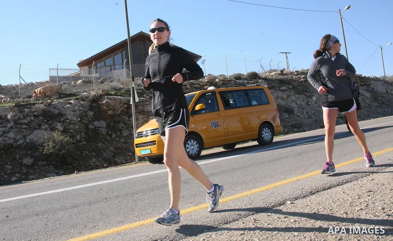 Palestinians, Israeli and foreign activists run during a marathon to support the farmers and land owners in the West Bank city of Hebron on Feb. 4,2012. Israeli troops detained a Palestinian and two foreign activists . P...