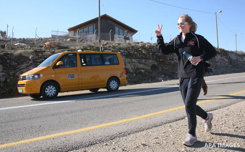 Palestinians, Israeli and foreign activists run during a marathon to support the farmers and land owners in the West Bank city of Hebron on Feb. 4,2012. Israeli troops detained a Palestinian and two foreign activists . P...