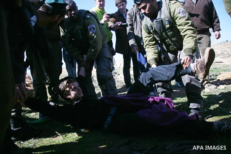 Israeli soldiers block the road in front of Palestinians, Israeli and foreign activists during a marathon to support the farmers and land owners in the West Bank city of Hebron on Feb. 4,2012. Israeli troops detained a P...