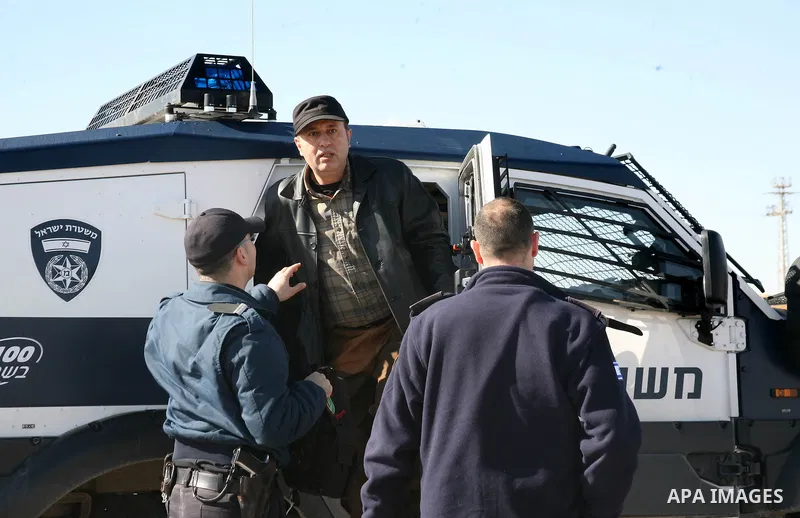Israeli soldiers block the road in front of Palestinians, Israeli and foreign activists during a marathon to support the farmers and land owners in the West Bank city of Hebron on Feb. 4,2012. Israeli troops detained a P...