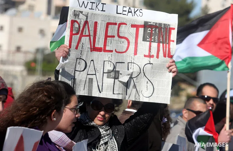 Palestinian activists hold banners during a protest against the peace talks in the West Bank city of Ramallah Saturday, February 4, 2012. Palestinian and Israeli negotiators met last week for the first time in more than...