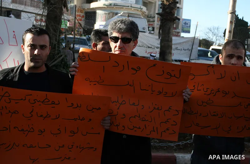 Palestinians protest against rising prices and taxes in the West Bank city of Ramalllah, Saturday, Feb. 4, 2012. Palestinian Authority Prime Minister Salam Fayyad has sparked a furor with a push to get Palestinians to pa...
