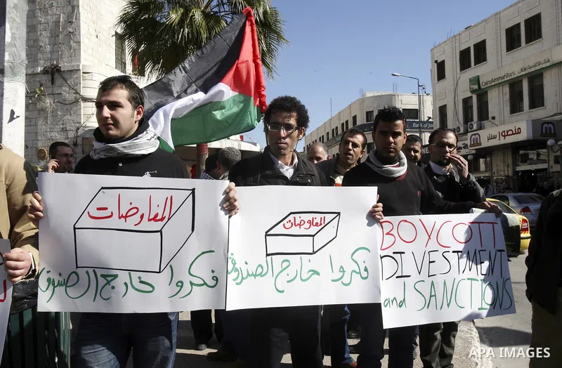 Palestinian activists hold banners during a protest against the peace talks in the West Bank city of Nablus, Saturday, February 4, 2012. Palestinian and Israeli negotiators met last week for the first time in more than a...
