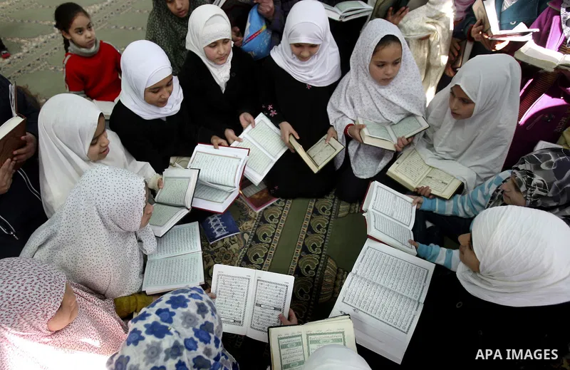 Palestinian Muslim girls read the Quran, as they celebrate the Prophet Muhammad's birthday at a mosque in the Balata refugee camp in the West Bank city of Nablus . Saturday, Feb. 4, 2012. Photo by Wagdi Eshtayah