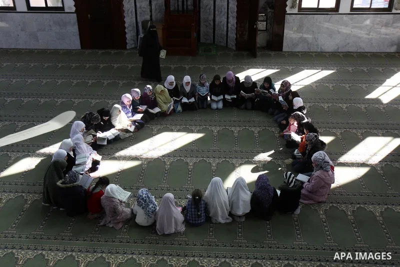 Palestinian Muslim girls read the Quran, as they celebrate the Prophet Muhammad's birthday at a mosque in the Balata refugee camp in the West Bank city of Nablus . Saturday, Feb. 4, 2012. Photo by Wagdi Eshtayah
