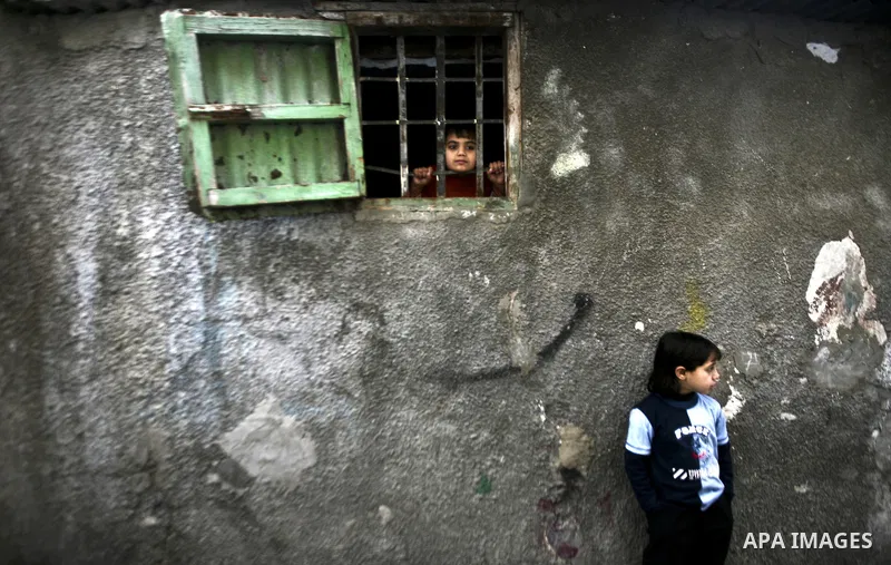Palestinian refugee girl stands in front of her house in the Jabaliya refugee camp in the northern area of the Gaza Strip on 05 February 2012. Photo by Ali Jadallah