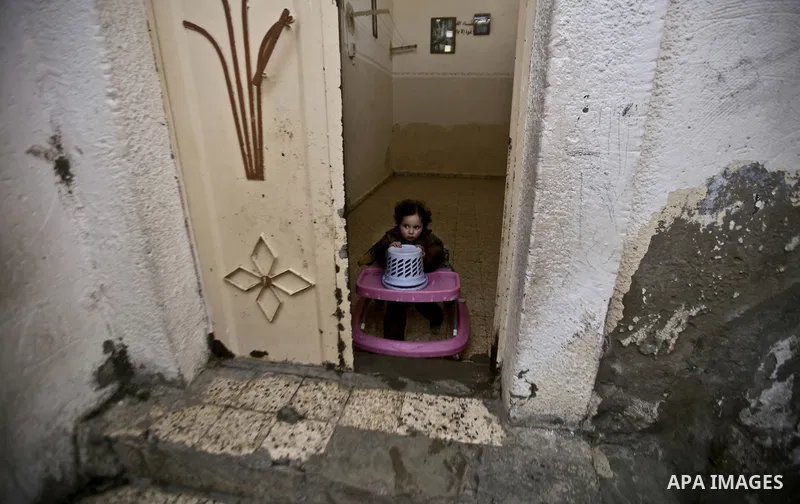 Palestinian refugee girl stands in front of her house in the Jabaliya refugee camp in the northern area of the Gaza Strip on 05 February 2012. Photo by Ali Jadallah