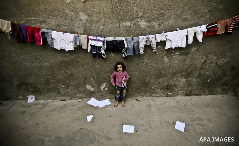 Palestinian refugee girl stands in front of her house in the Jabaliya refugee camp in the northern area of the Gaza Strip on 05 February 2012. Photo by Ali Jadallah