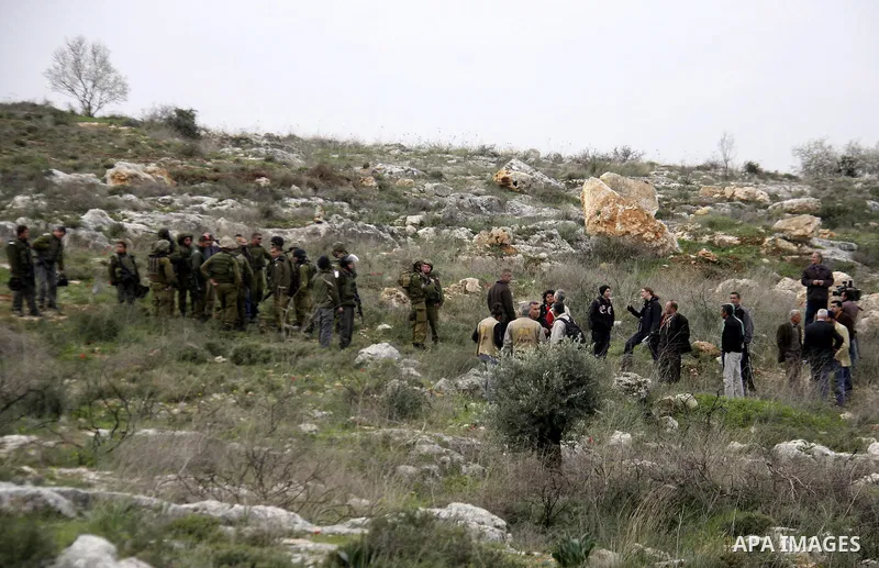 Israeli soldiers scuffle with Palestinians during a clash between Jewish settlers and Palestinians over farming land between the Jewish settlement Shiloh and the West Bank the village of Qusrah near Nablus, Feb. 06, 2012...