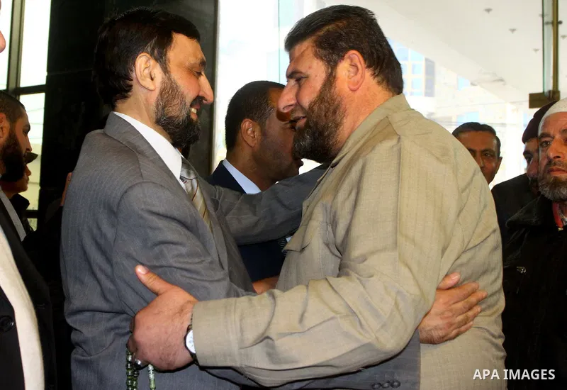 A Palestinian member of Hamas movement political bureau, Emad Al-Alami is welcomed by Hamas movement leaders and others after his arrival to Gaza Strip, in Gaza city on Feb. 6,2012. Al-Almi returned to Gaza Strip on Mond...
