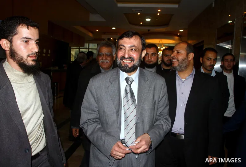 A Palestinian member of Hamas movement political bureau, Emad Al-Alami is welcomed by Hamas movement leaders and others after his arrival to Gaza Strip, in Gaza city on Feb. 6,2012. Al-Almi returned to Gaza Strip on Mond...