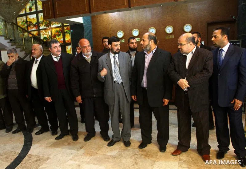 A Palestinian member of Hamas movement political bureau, Emad Al-Alami is welcomed by Hamas movement leaders and others after his arrival to Gaza Strip, in Gaza city on Feb. 6,2012. Al-Almi returned to Gaza Strip on Mond...