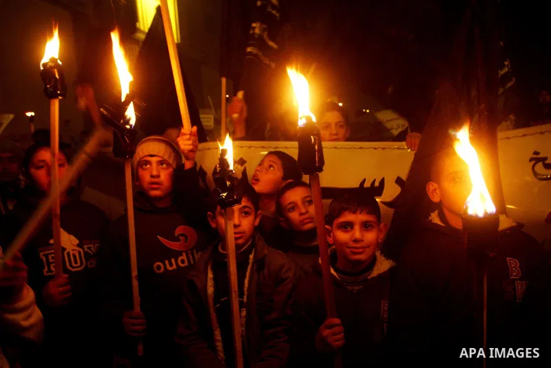 A Palestinian boy holds a torch during a protest in Dir al-Balah in the central Gaza Strip, calling for the release of Palestinian prisoners held in Israeli jails February 6, 2012. Photo by Ashraf Amra