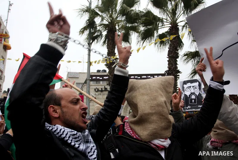 Palestinians demonstrate in solidarity with Khader Adnan, a senior member of Islamic Jihad jailed in Israel, who has been on a hunger strike for over seven weeks, during a protest in the West Bank city of Ramallah, Tuesd...
