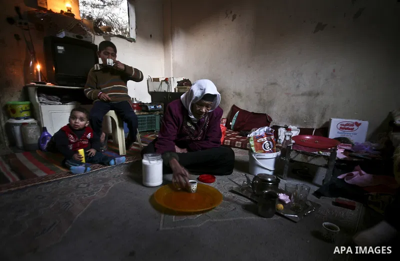 Em Sameer, 90, lights a cigarette as she sits in her room during an electricity power cut in the Jabaliya refugee camp, Gaza Strip, 07 February 2012. Electricity is reported to be cut for 12 hours every day as part of a...
