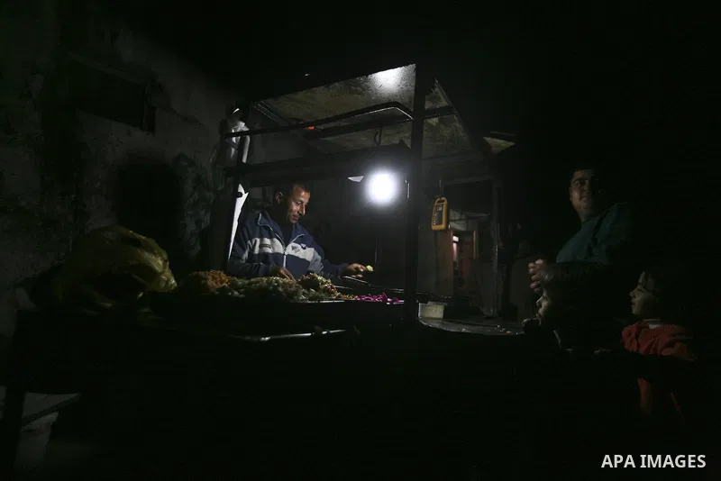 A Palestinian vendor sells Falafel, a traditional Arab food, at his stand during an electricity power cut in the Jabaliya refugee camp, Gaza Strip, 07 February 2012. Electricity is reported to be cut for 12 hours every d...