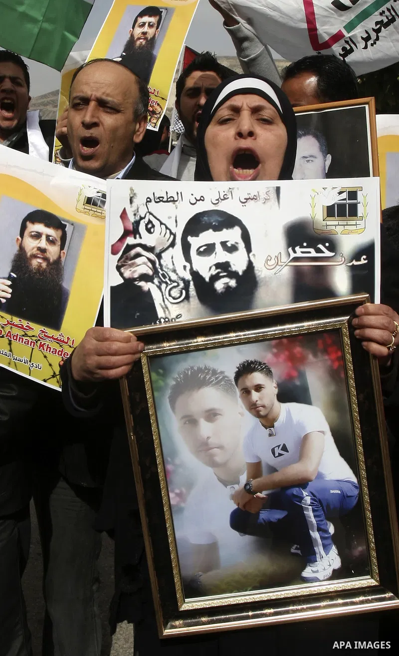 Palestinians demonstrate in solidarity with Khader Adnan, a senior member of Islamic Jihad jailed in Israel, who has been on a hunger strike for over seven weeks, during a protest in the West Bank city of Nablus, Feb. 7,...