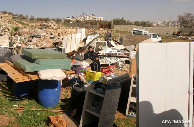 Palestinians collect their belongings after their house was demolished by Israeli bulldozers in the Arab east Jerusalem neighbourhood of Beit Hanina on February 9, 2012. Israel regularly demolishes homes in Arab east Jer...