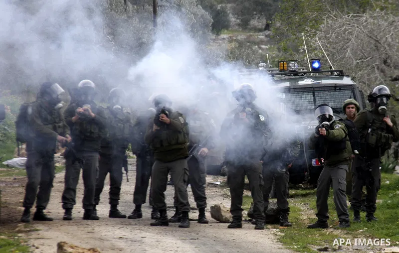 Israeli soldiers fire teargas at Palestinian protesters during a demonstration against the expropriation of Palestinian land by Israel in the village of Kfar Qaddum, near the West Bank city of Nablus, on February 10, 201...
