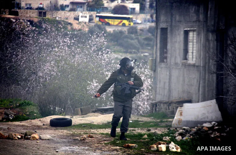 Israeli soldiers fire teargas at Palestinian protesters during a demonstration against the expropriation of Palestinian land by Israel in the village of Kfar Qaddum, near the West Bank city of Nablus, on February 10, 201...