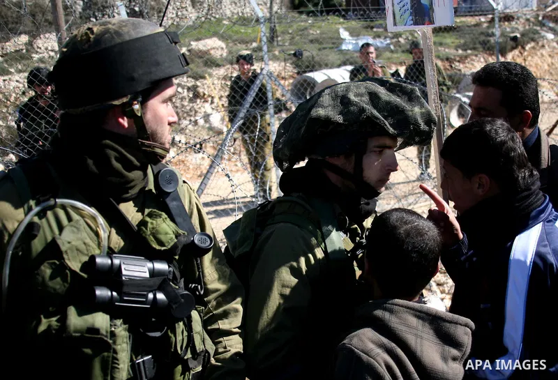 Israeli soldiers arrest a demonstrator during scuffles with Palestinians in a weekly protest against Israel's controversial separation barrier in the West Bank village of Beit Omar, close to city of Hebron and the settle...