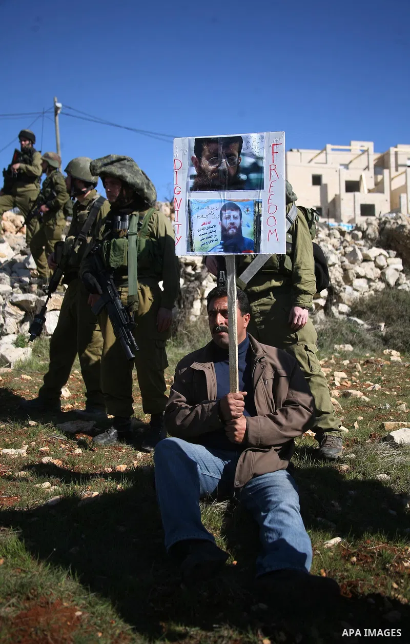Israeli soldiers arrest a demonstrator during scuffles with Palestinians in a weekly protest against Israel's controversial separation barrier in the West Bank village of Beit Omar, close to city of Hebron and the settle...