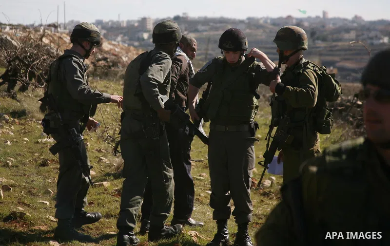 Israeli soldiers arrest a demonstrator during scuffles with Palestinians in a weekly protest against Israel's controversial separation barrier in the West Bank village of Beit Omar, close to city of Hebron and the settle...