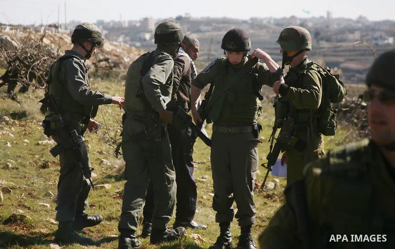 Israeli soldiers arrest a demonstrator during scuffles with Palestinians in a weekly protest against Israel's controversial separation barrier in the West Bank village of Beit Omar, close to city of Hebron and the settle...
