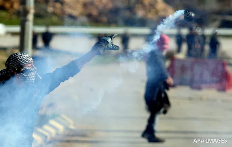 Palestinian protesters clash with Israeli troops fire tear gas during a protest outside the Ofer military prison in support of Khader Adnan, 33, a senior member of Islamic Jihad jailed in Israel and who has been on a hun...