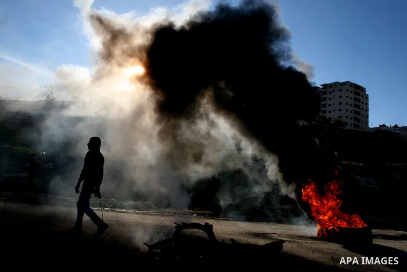 Palestinian protesters clash with Israeli troops fire tear gas during a protest outside the Ofer military prison in support of Khader Adnan, 33, a senior member of Islamic Jihad jailed in Israel and who has been on a hun...