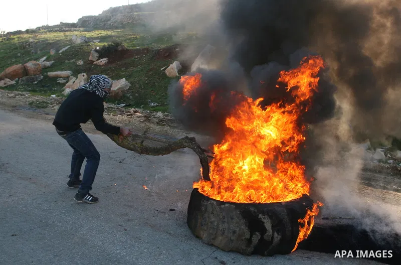 Palestinian protesters clash with Israeli troops fire tear gas during a protest outside the Ofer military prison in support of Khader Adnan, 33, a senior member of Islamic Jihad jailed in Israel and who has been on a hun...