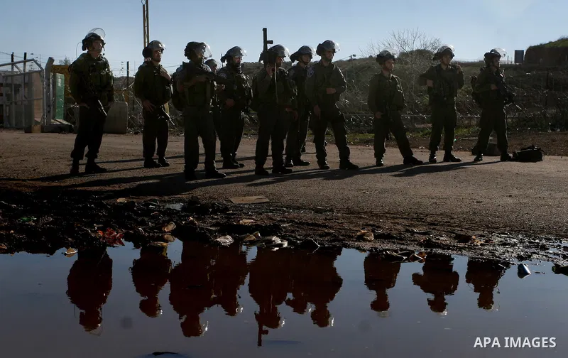 Israeli troops fire tear gas towards Palestinian demonstrators during a protest outside the Ofer military prison in support of Khader Adnan, 33, a senior member of Islamic Jihad jailed in Israel who has been on a hunger...