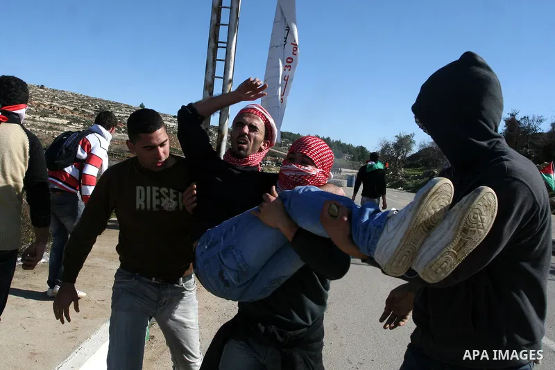 Palestinian protesters clash with Israeli troops fire tear gas during a protest outside the Ofer military prison in support of Khader Adnan, 33, a senior member of Islamic Jihad jailed in Israel and who has been on a hun...