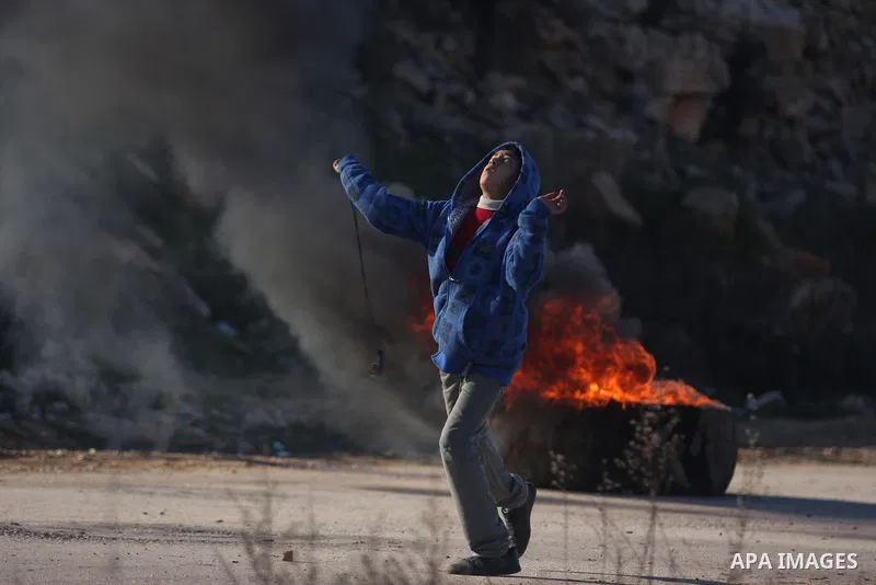 Palestinian protesters clash with Israeli troops fire tear gas during a protest outside the Ofer military prison in support of Khader Adnan, 33, a senior member of Islamic Jihad jailed in Israel and who has been on a hun...