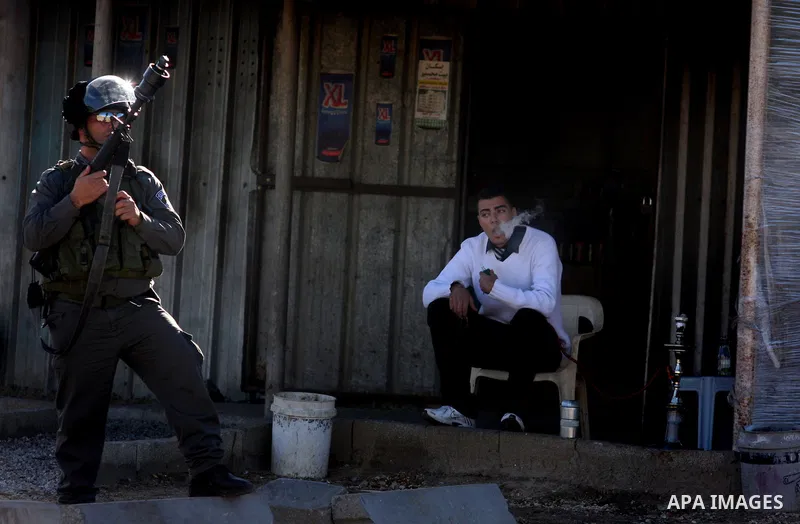Israeli troops fire tear gas towards Palestinian demonstrators during a protest outside the Ofer military prison in support of Khader Adnan, 33, a senior member of Islamic Jihad jailed in Israel who has been on a hunger...