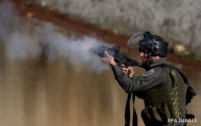 Israeli troops fire tear gas towards Palestinian demonstrators during a protest outside the Ofer military prison in support of Khader Adnan, 33, a senior member of Islamic Jihad jailed in Israel who has been on a hunger...
