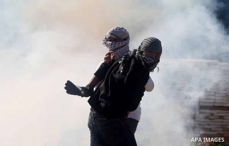 Palestinian protesters clash with Israeli troops fire tear gas during a protest outside the Ofer military prison in support of Khader Adnan, 33, a senior member of Islamic Jihad jailed in Israel and who has been on a hun...
