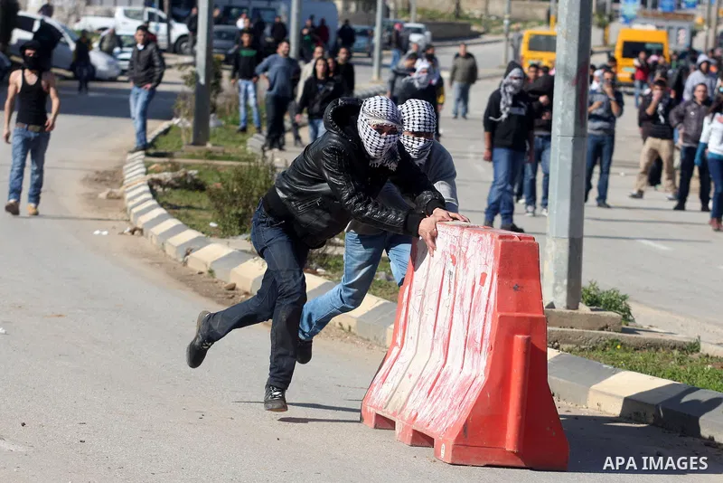 Palestinian protesters clash with Israeli troops fire tear gas during a protest outside the Ofer military prison in support of Khader Adnan, 33, a senior member of Islamic Jihad jailed in Israel and who has been on a hun...