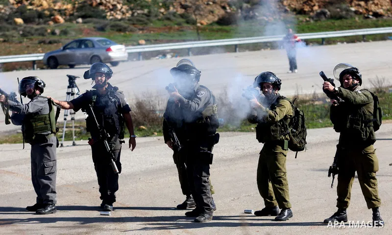Israeli troops fire tear gas towards Palestinian demonstrators during a protest outside the Ofer military prison in support of Khader Adnan, 33, a senior member of Islamic Jihad jailed in Israel who has been on a hunger...