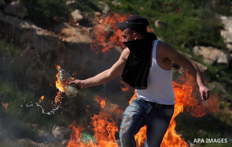 Palestinian protesters clash with Israeli troops fire tear gas during a protest outside the Ofer military prison in support of Khader Adnan, 33, a senior member of Islamic Jihad jailed in Israel and who has been on a hun...