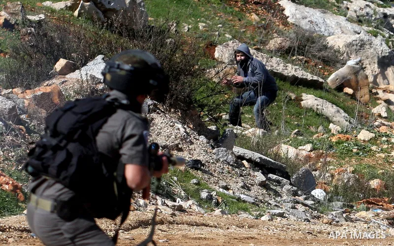 Palestinian protesters clash with Israeli troops fire tear gas during a protest outside the Ofer military prison in support of Khader Adnan, 33, a senior member of Islamic Jihad jailed in Israel and who has been on a hun...