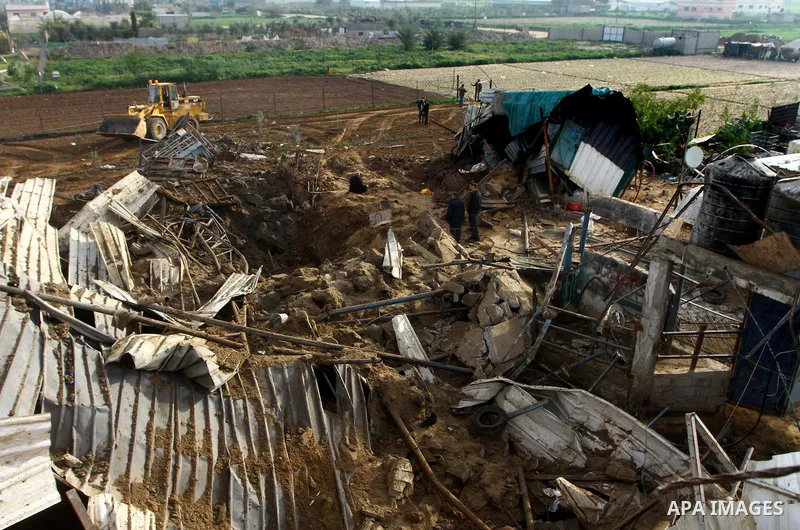 Palestinians inspect damages following Israeli air strikes in Gaza City on February 12, 2012. A Palestinian man died after being wounded in a series of retaliatory Israeli air strikes, Gaza medical sources said. Photo by...
