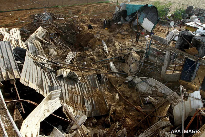 Palestinians inspect damages following Israeli air strikes in Gaza City on February 12, 2012. A Palestinian man died after being wounded in a series of retaliatory Israeli air strikes, Gaza medical sources said. Photo by...