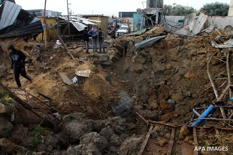 Palestinians inspect damages following Israeli air strikes in Gaza City on February 12, 2012. A Palestinian man died after being wounded in a series of retaliatory Israeli air strikes, Gaza medical sources said. Photo by...