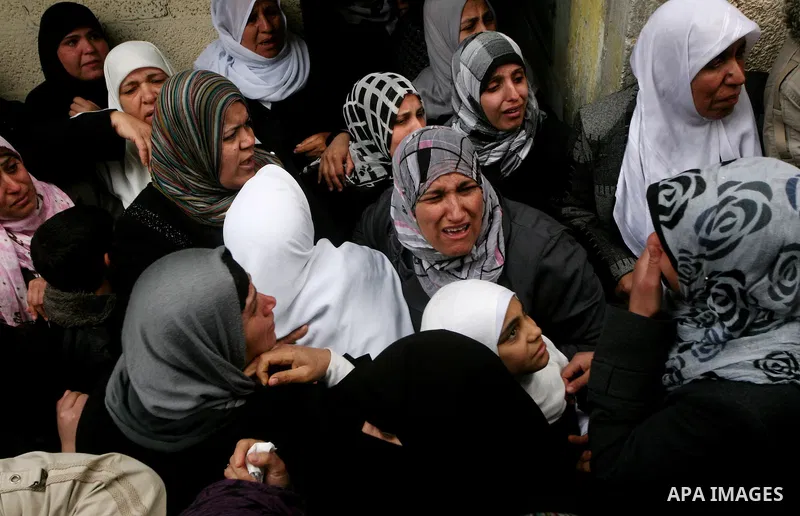 Relatives of Abed Kareem Zaytoneya mourns next to his body during his funeral in Gaza City February 12, 2012. An Israeli air strike on the Gaza Strip killed a Palestinian civilian, Zaytoneya, on Sunday, hospital official...