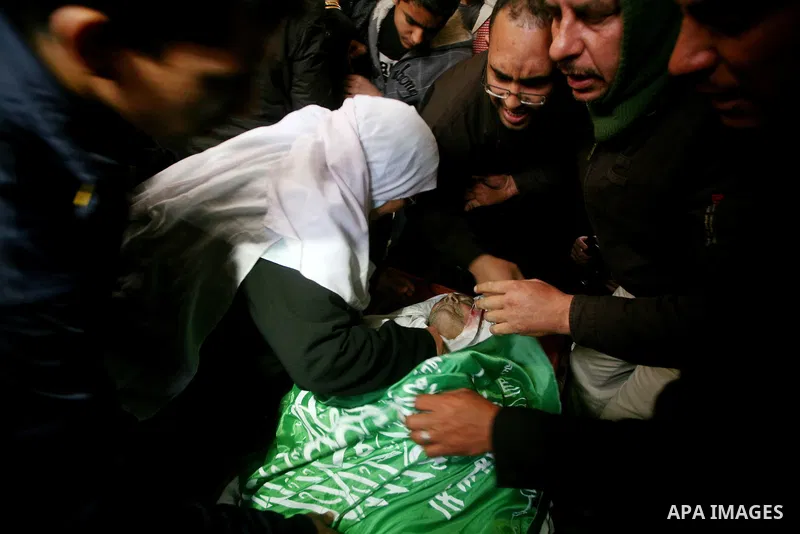 The daughter of Abed Kareem Zaytoneya mourns next to his body during his funeral in Gaza City February 12, 2012. An Israeli air strike on the Gaza Strip killed a Palestinian civilian, Zaytoneya, on Sunday, hospital offic...